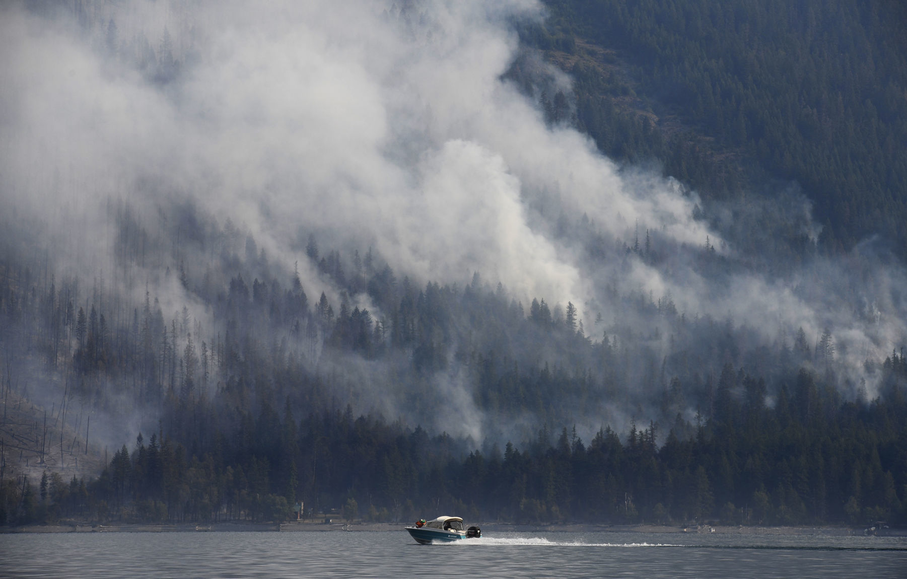Boat passes burning section of fire